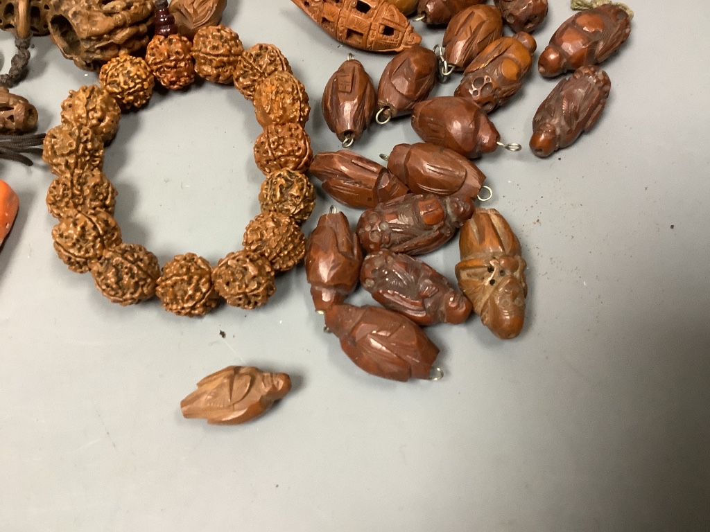 An assortment of Chinese peach stone and a nut carvings